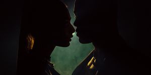 sensuous young woman close to kiss man against light background silhouette of man and woman closing to kiss shadow of two lovers forbidden love close to kiss passionate couple intimacy