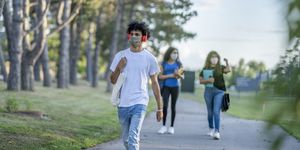 group of students wearing reusable face masks while walking together on campus