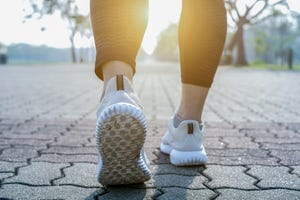 runner feet running on road closeup on shoe