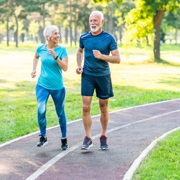 a senior man and woman running