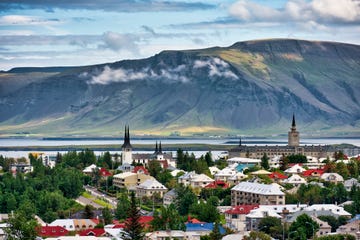 a city with a body of water in the background