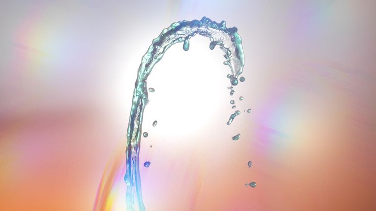 water splash forming arch against multicolor background