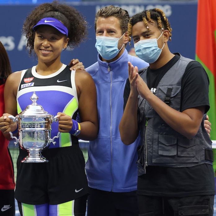 new york, new york   september 12 naomi osaka 3rd r of japan holds the trophy and celebrates with her team and boyfriend, rapper ybn cordae r, after winning her women's singles final match against victoria azarenka of belarus on day thirteen of the 2020 us open at the usta billie jean king national tennis center on september 12, 2020 in the queens borough of new york city photo by al bellogetty images