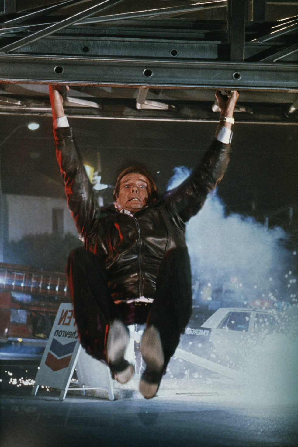 a matte shot of english actor roger moore as 007, hanging from a fire engine ladder in a publicity still for the james bond film 'a view to a kill', 1984 the background has been composited in hand, to simulate the front projection effect used in the film photo by keith hamsheregetty images