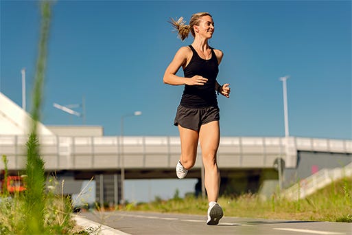 low angle view of female athlete running outdoors. copy space.