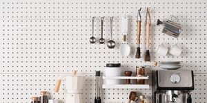espresso coffee maker and accessories knolling on white colored pegboard background