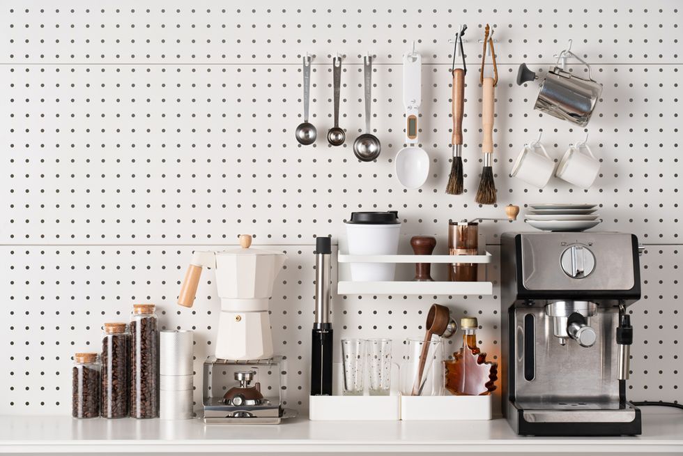 espresso coffee maker and accessories knolling on white colored pegboard background
