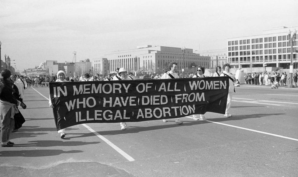 view of pro choice demonstrators as they carry a large banner on pennsylvania avenue nw between 3rd st sw and 1st st nw during the march for womens lives, washington dc, march 9, 1986 the banner reads in memory of all women who have died from illegal abortion photo by ann e zellegetty images