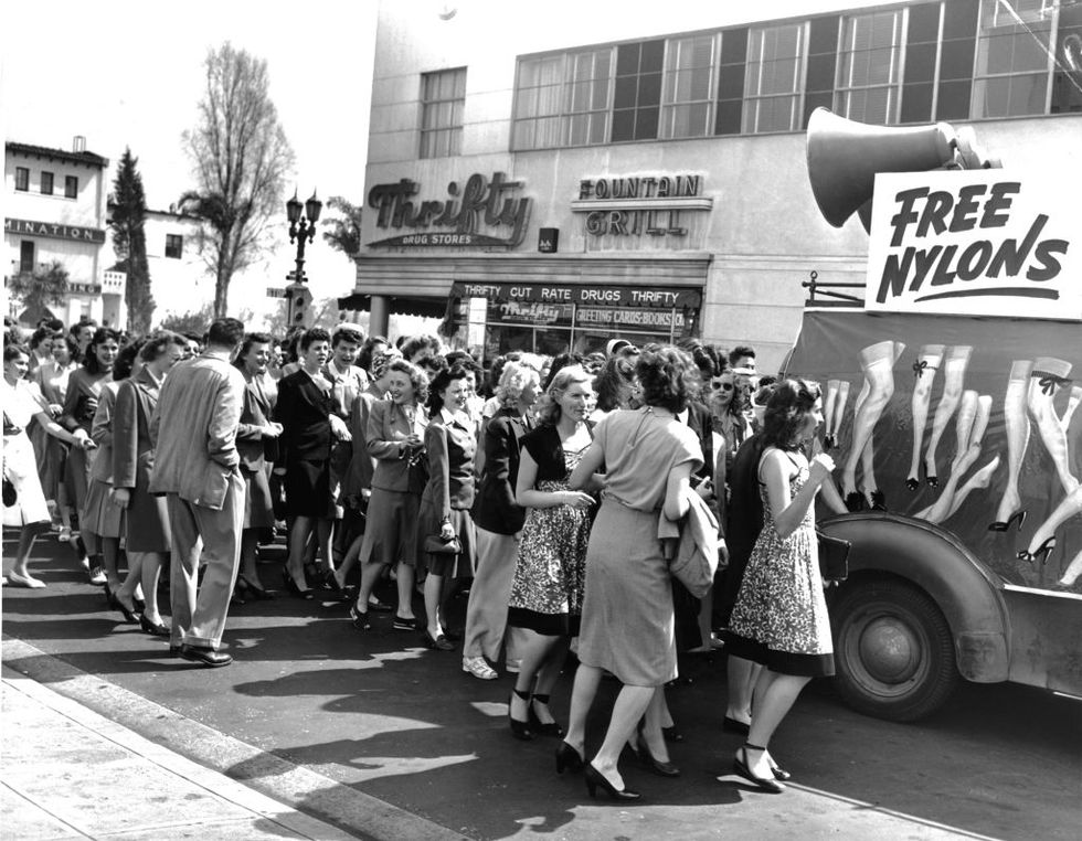 crowd of you women on the street rushing a van handing out free nylons photo by cameriquegetty images