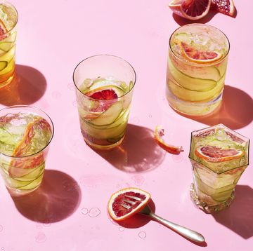 grid of cocktails on pink background with fruit and magazine