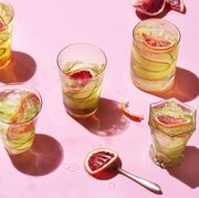 grid of cocktails on pink background with fruit and magazine