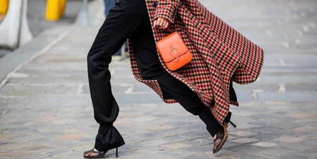 paris, france   october 08 leonie hanne is seen wearing jw anderson checkered red coat, red jw anderson bag, white dion lee top, black  jw anderson pants, bottega veneta heels during a street style fashion photo session on october 08, 2020 in paris, france photo by christian vieriggetty images