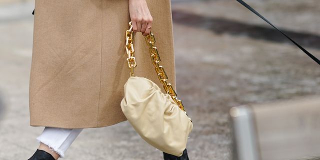 paris, france   october 06 a guest wears a beige bag, a leather pouch bottega veneta bag with a golden chain, outside miu miu, during paris fashion week   womenswear spring summer 2021, on october 06, 2020 in paris, france photo by edward berthelotgetty images