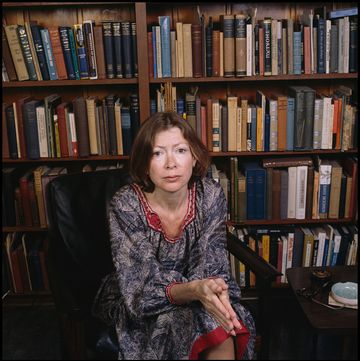 portrait of american author joan didion as she sits in a chair in front of a bookshelf, berkeley, california, april 1981 photo by janet friesgetty images