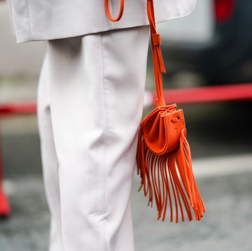 paris, france   september 30 a guest wears an orange bag with fringes, outside kenzo, during paris fashion week   womenswear spring summer 2021, on september 30, 2020 in paris, france photo by edward berthelotgetty images