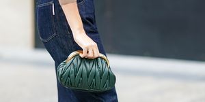 paris, france   october 06 a guest wears a green woven leather miu miu bag, blue hem jeans, outside miu miu, during paris fashion week   womenswear spring summer 2021, on october 06, 2020 in paris, france photo by edward berthelotgetty images