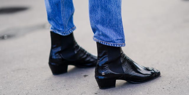 paris, france   october 06 a guest wears blue denim jeans, black leather pointy shiny boots with chanel logo, outside chanel, during paris fashion week   womenswear spring summer 2021, on october 06, 2020 in paris, france photo by edward berthelotgetty images
