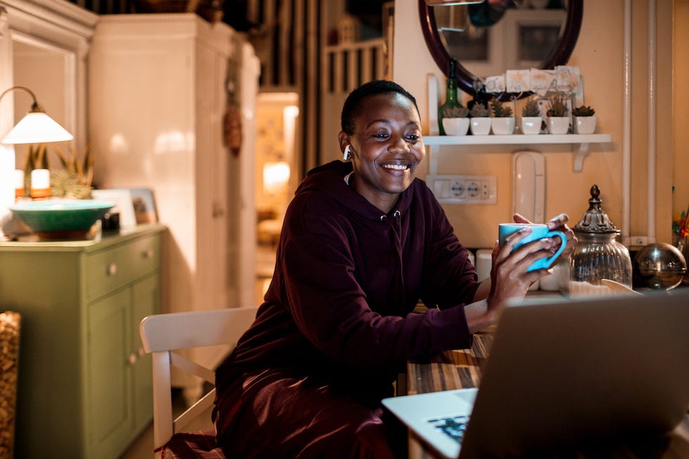 close up of a young woman using her laptop at home