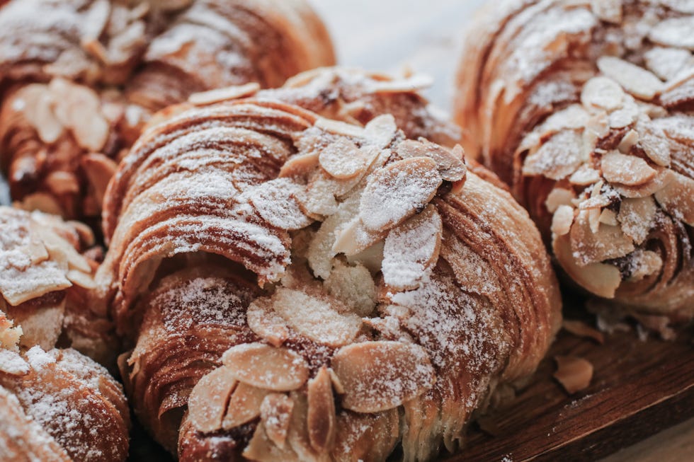 underrated costco finds almond croissant bakery homemade on the table traditional french breakfast tray with gold and crispy croissants