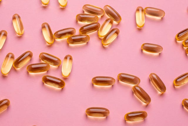 vitamins omega 3 6 9 fish oil , vitamin d on a pink background for health lifestyle top view