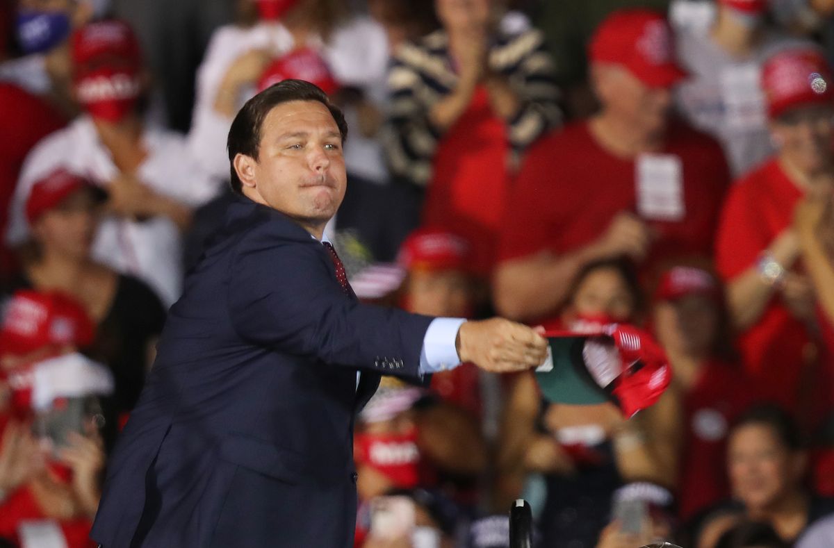 opa locka, florida   november 01 florida gov ron desantis tosses hats to the crowd before the arrival of us president donald trump for his campaign event at miami opa locka executive airport on november 1, 2020 in opa locka, florida president trump continues to campaign against democratic presidential nominee joe biden leading up to the november 3rd election day photo by joe raedlegetty images