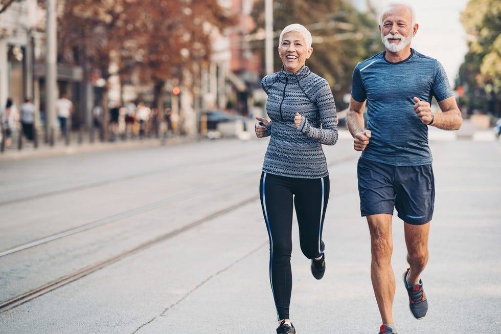 couple of seniors jogging outdoors in the city