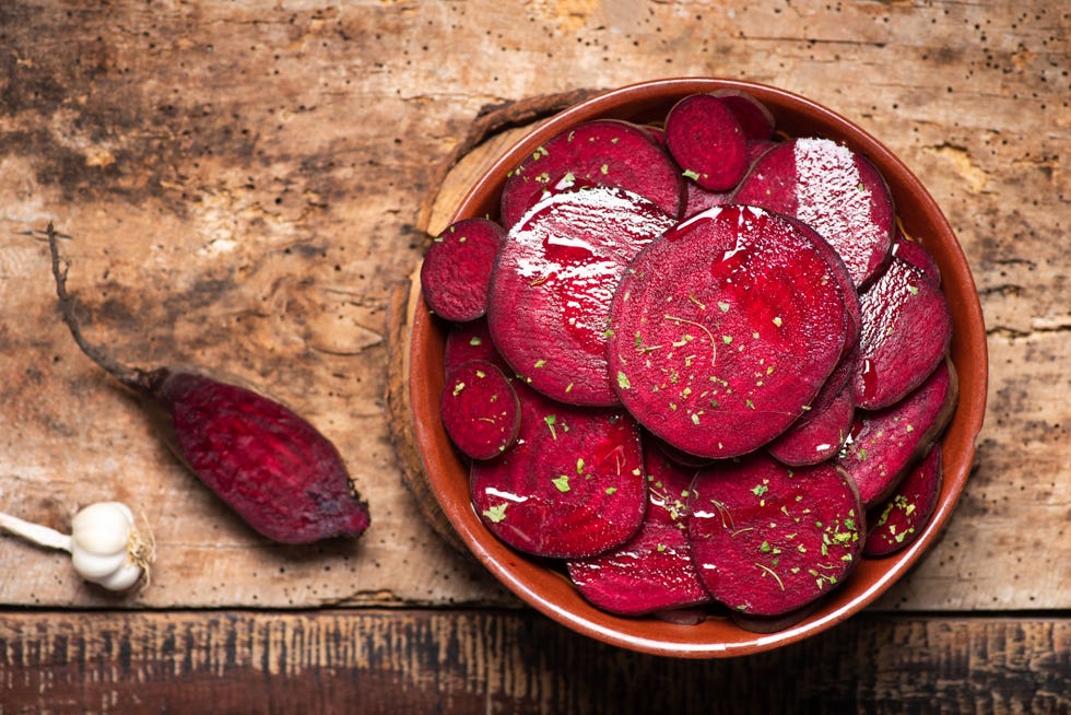 beetroot salad with parsley in a bowl on a rustic wooden table