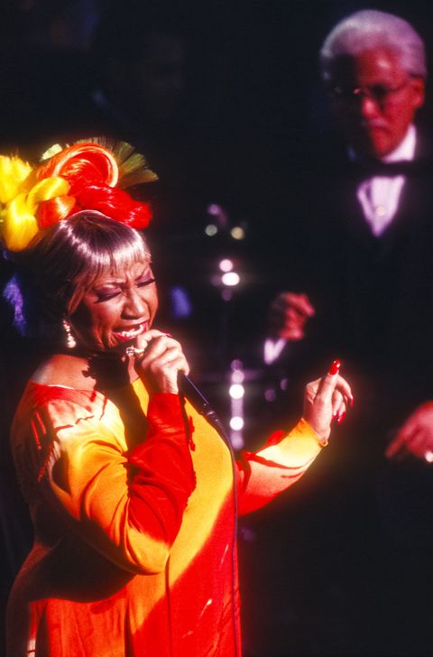 cuban american salsa singer celia cruz 1925   2003 performs, with johnny pacheco on flute, at el concierto por la vida, an aids benefit for gmhc the gay mens health crisis health service, at avery fisher hall, lincoln center, new york, new york, november 16, 1998 photo by jack vartoogiangetty images