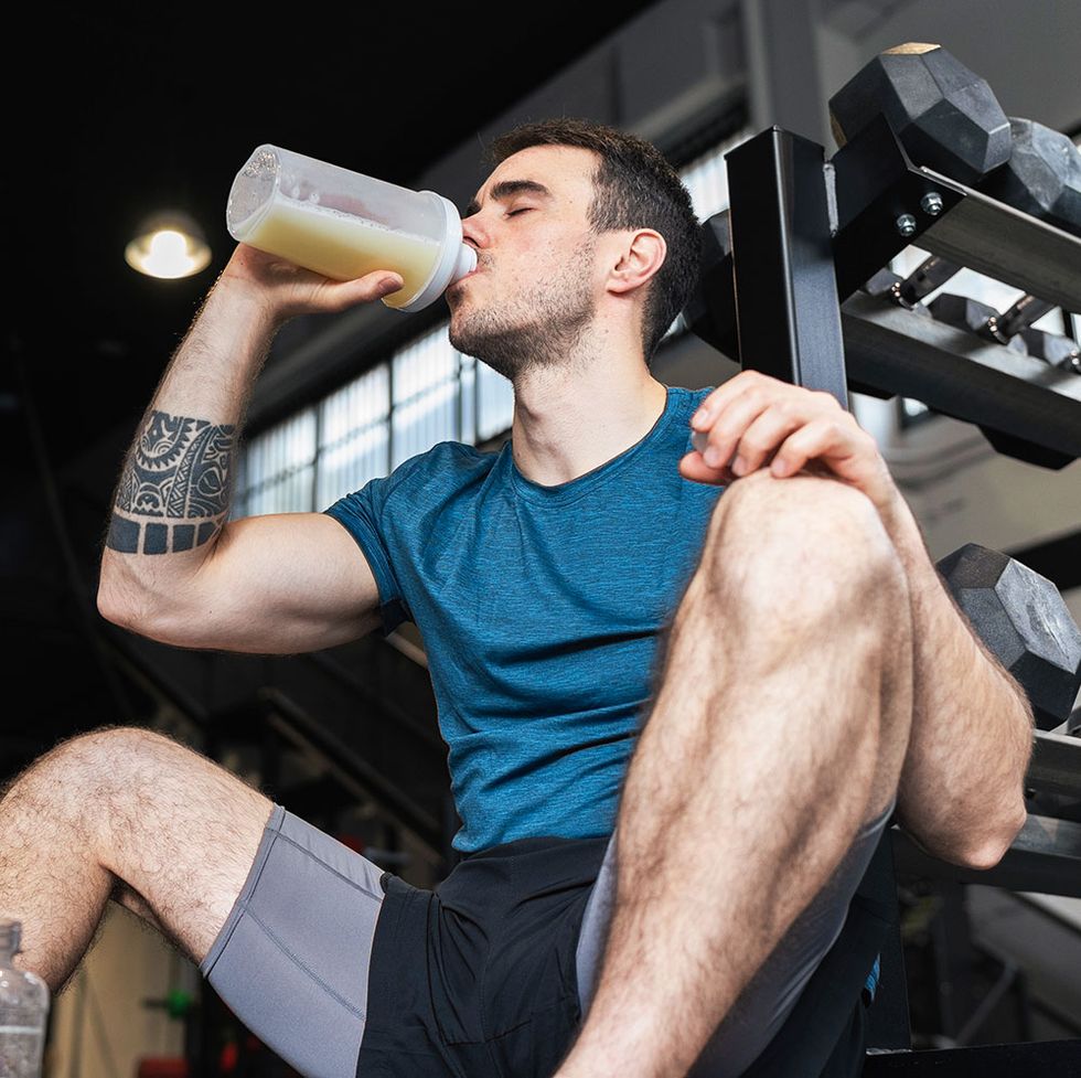 man drinking shake in gym
