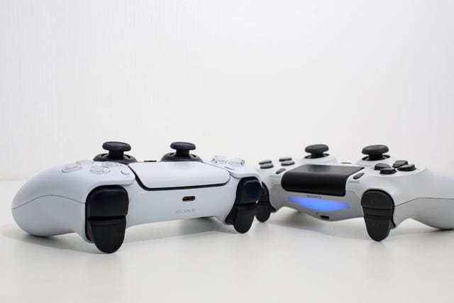 riga, latvia   november 23, 2020 sony playstation 5 and sony playstation 4 controllers on white background
