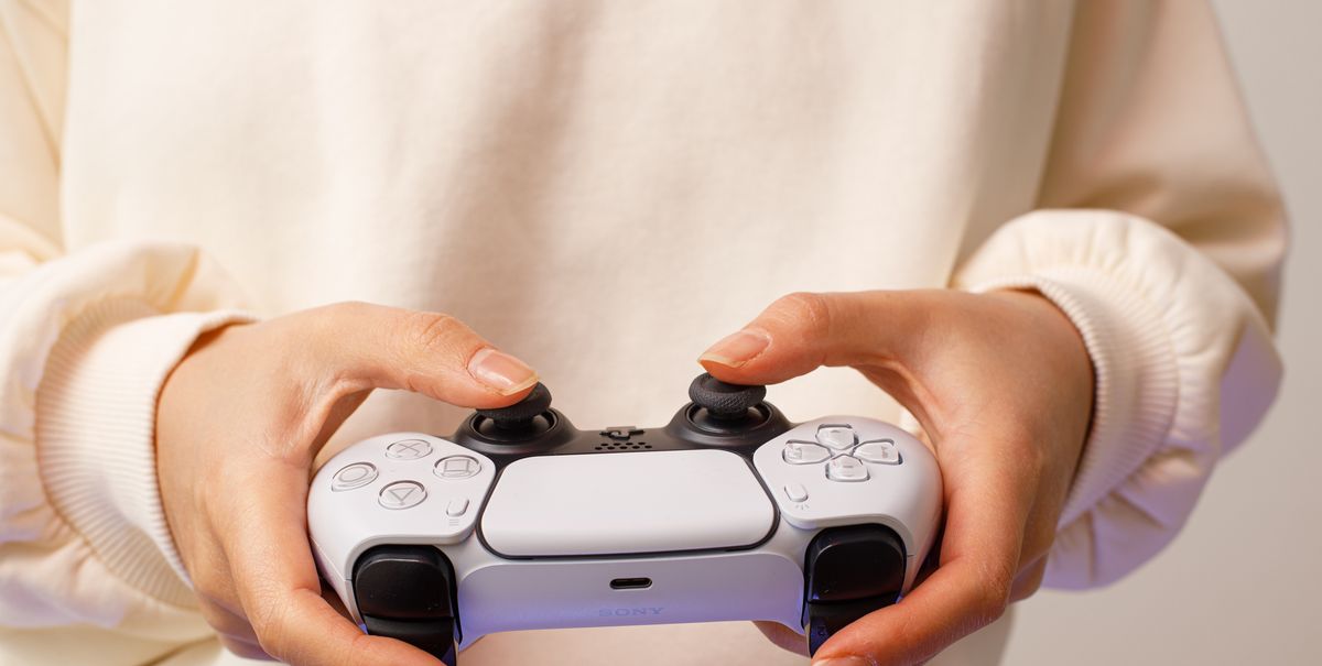 riga, latvia   november 23 2020 playstation 5 sony reveals ps5 console and games dualsense controller woman holding joystick