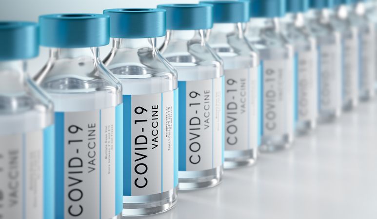row covid 19 or coronavirus vaccine flasks on white background