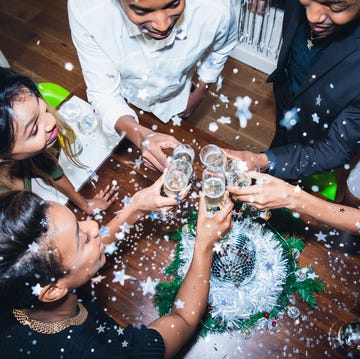 High angle view of friends toasting champagne at party high angle view of friends toasting champagne at party