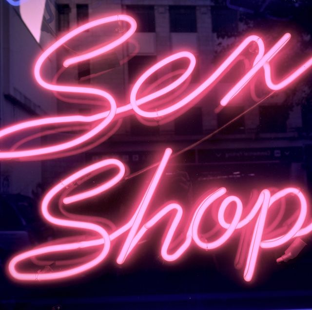 neon lights posting the way to sex shops in the soho district of central london