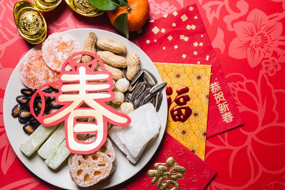 flat lay chinese new year traditional snacks with red envelops