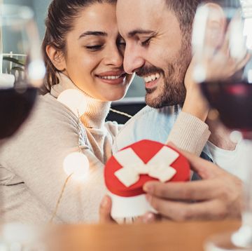 man and woman on valentines day with wine and gifts