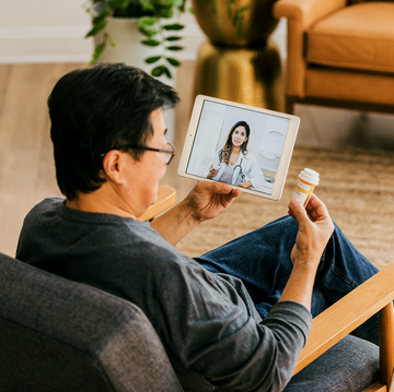 during a virtual appointment, a senior man discusses his current medications with a female doctor
