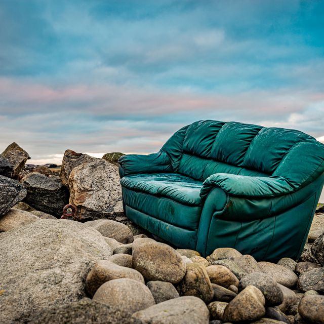 an old couch placed in a perfect spot at the coast wonder what use it has been for