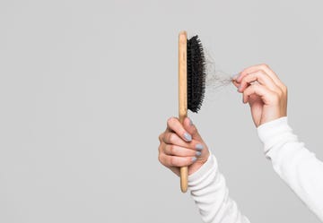hair loss problem, postpartum period, menstrual disorder, stress many hair fall after combing in hairbrush female untangles her hair with a comb, copy space