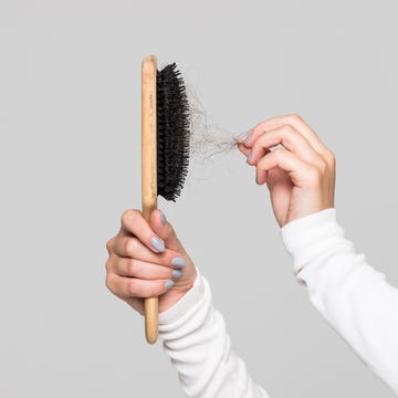 hair fall after combing in hairbrush, isolated. Hair loss problem, postpartum period, menstrual disorder, stress hair loss problem, postpartum period, menstrual disorder, stress many hair fall after combing in hairbrush female untangles her hair with a comb, copy space