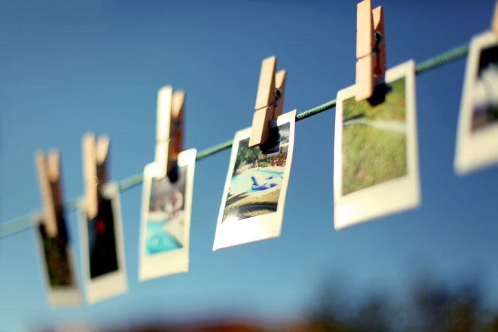 summery pictures hanging from washing line using clothespins