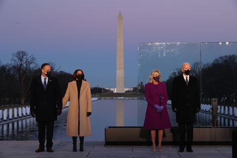 washington, dc   january 19 l r douglas emhoff, us vice president elect kamala harris, dr jill biden and us president elect joe biden attend a memorial service to honor the nearly 400,000 american victims of the coronavirus pandemic at the lincoln memorial reflecting pool january 19, 2021 in washington, dc as the nations capital has become a fortress city of roadblocks, barricades and 20,000 national guard troops due to heightened security around bidens inauguration, 400 lights were placed around the reflecting pool to honor the nearly 400,000 americans killed by covid 19 photo by chip somodevillagetty images
