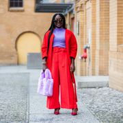 berlin, germany   january 19 lois opoku red jacket hm trend, dior shoes, asos fluffy bag in pink, dorothee schumacher turtleneck, sunglasses bottega veneta during the mercedes benz fashion week berlin january 2021 on january 19, 2021 in berlin, germany photo by christian vieriggetty images