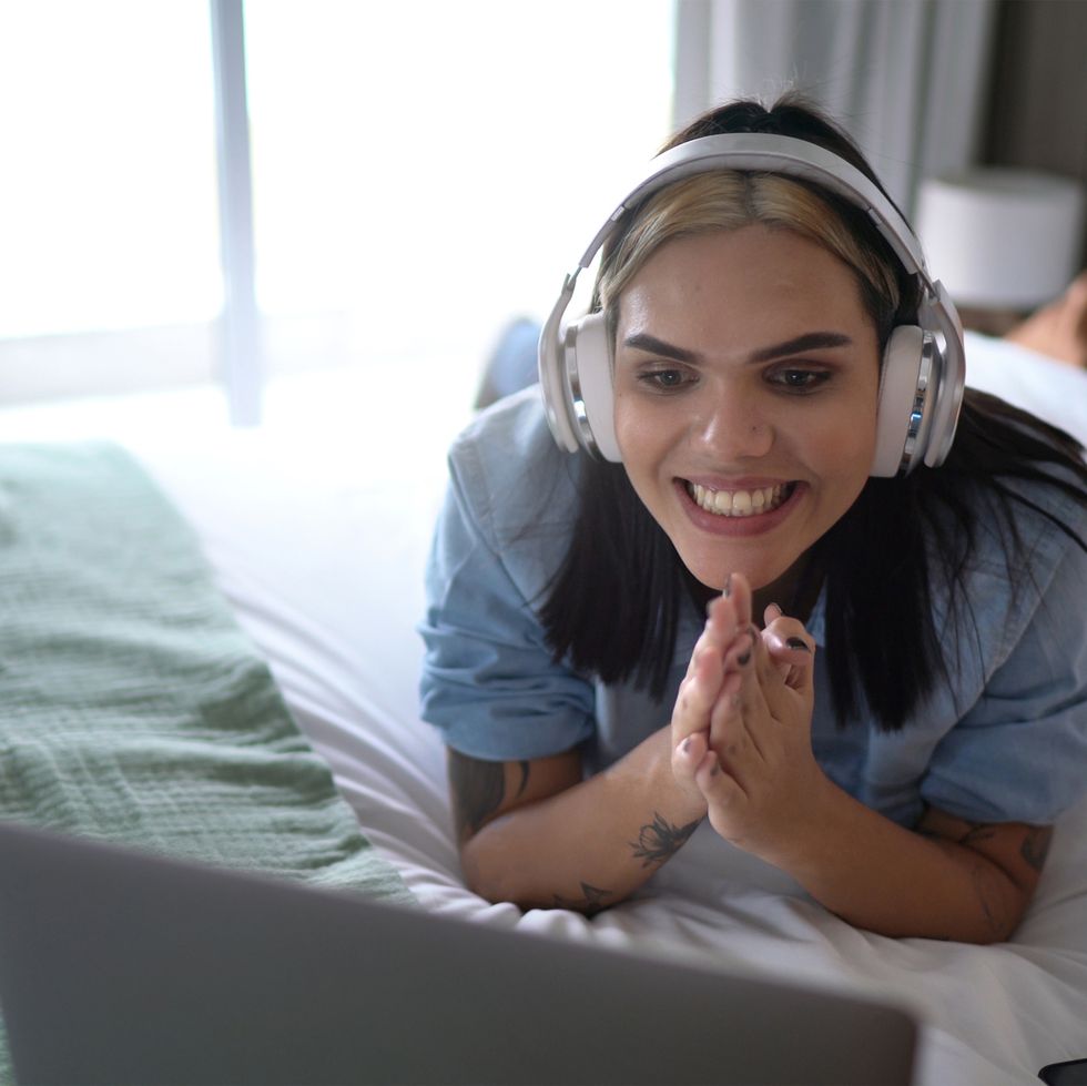 woman watching something on laptop or on a video call at home