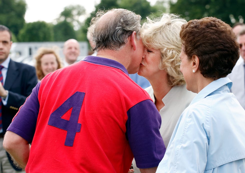 prince charles, prince of wales kisses camilla, duchess of cornwall as she presents him with his prize
