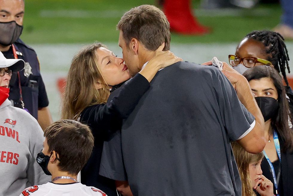 tampa, florida   february 07 tom brady 12 of the tampa bay buccaneers celebrates with gisele bundchen after winning super bowl lv at raymond james stadium on february 07, 2021 in tampa, florida photo by kevin c coxgetty images