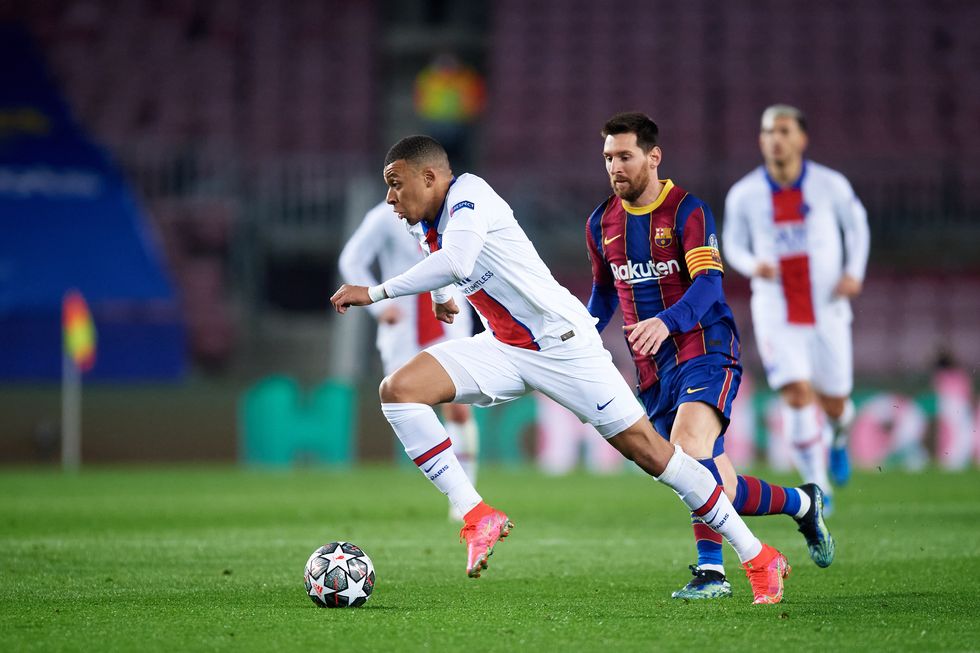 barcelona, spain   february 16 kylian mbappe of paris saint germain runs with the ball past lionel messi of fc barcelona during the uefa champions league round of 16 match between fc barcelona and paris saint germain at camp nou on february 16, 2021 in barcelona, spain sporting stadiums around spain remain under strict restrictions due to the coronavirus pandemic as government social distancing laws prohibit fans inside venues resulting in games being played behind closed doors  photo by alex caparros   uefauefa via getty images
