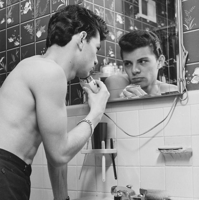 american actor, singer, and teen idol frankie avalon shaving in front of a mirror in a bathroom, us, circa 1960 photo by archive photosgetty images