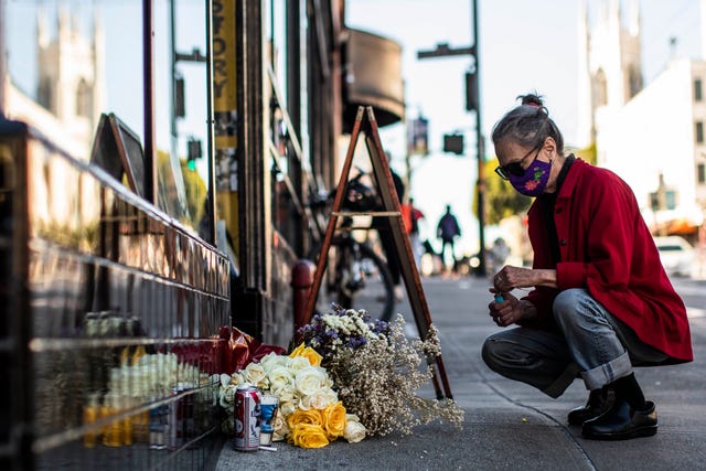 san francisco, ca   feb 23  a woman lights incense at a memorial outside city lights bookstore in remembrance of co founder lawrence ferlinghetti, a poet, publisher, painter, a pivotal figure to the beats movement, after the news of his death at the age of 101, in san francisco, california tuesday, february 23, 2021stephen lam  the san francisco chronicle via getty images