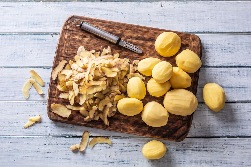 peeled potatoes on a cutting board   top of view